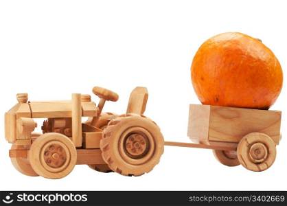 Orange pumpkin in wooden toy tractor cart, isolated on white background.