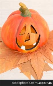 Orange pumpkin lantern with a spooky face smiling