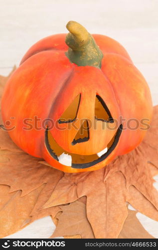 Orange pumpkin lantern with a spooky face smiling