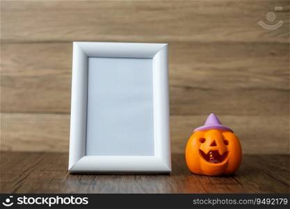 Orange pumpkin on table and frame with copy space for text. Happy Halloween day, Hello October, fall autumn season, Festive, party and holiday concept