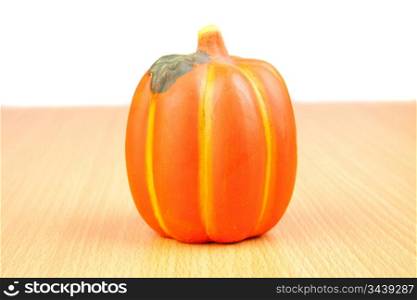 Orange pumpkin on wooden surface isolated on white background