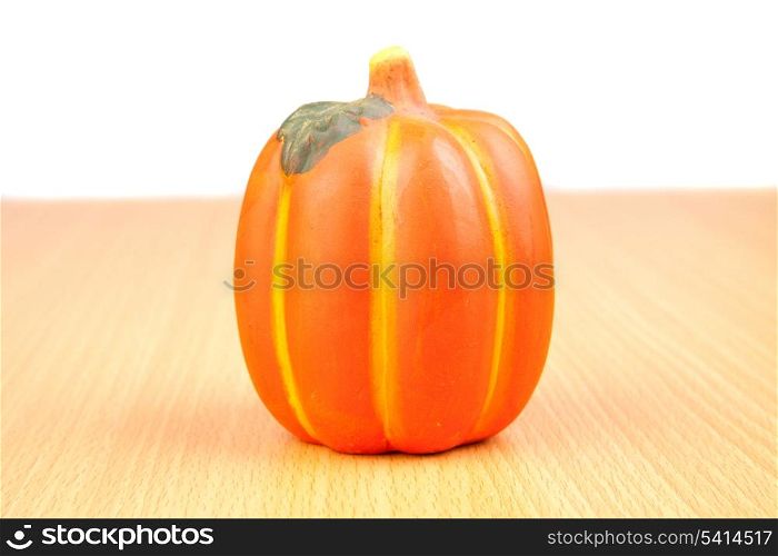 Orange pumpkin on wooden surface isolated on white background
