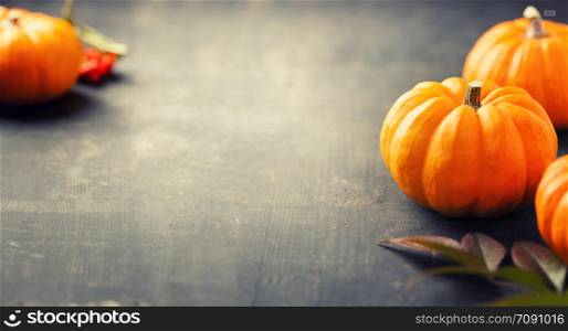 Orange pumpkins on a dark wooden background. pumpkins on a wooden background with copyspace