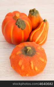 Orange pumpkins on a wooden grey background