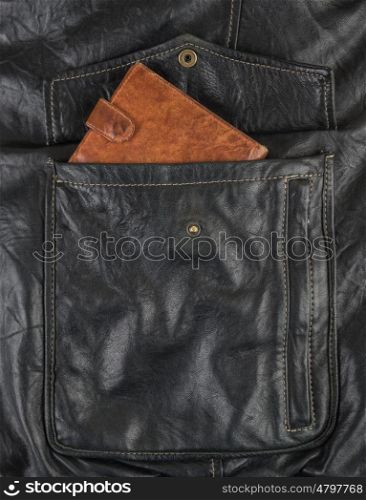 Orange purse in the pocket of black leather jacket