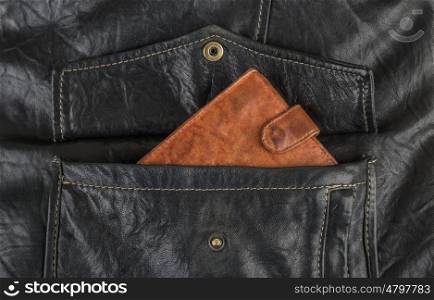 Orange purse in the pocket of black leather jacket