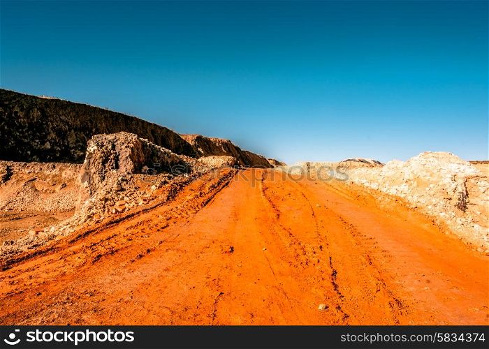 Orange road going through a canyon