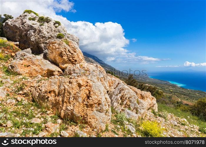 Orange rocks on mountain near coast in Kefalonia Greece