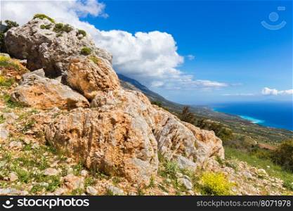 Orange rocks on mountain near coast in Kefalonia Greece
