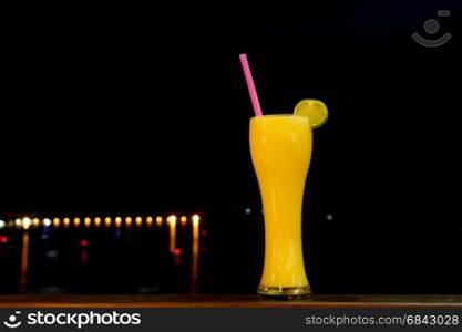 orange shake drink in glass with black background