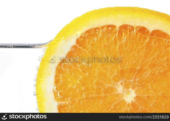 Orange slice in water on white background