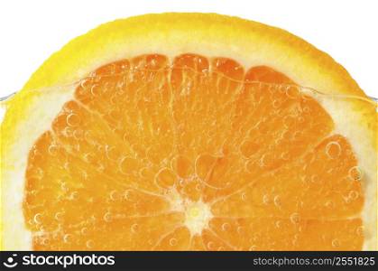 Orange slice in water with air bubbles on white background