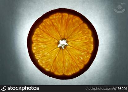 orange slice on grey background, illuminated