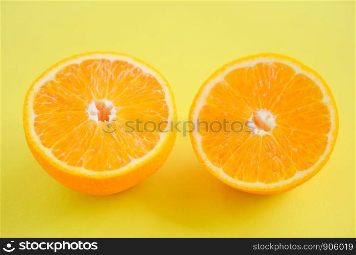 orange slice on yellow background / close up of fresh Orange fruit , top view