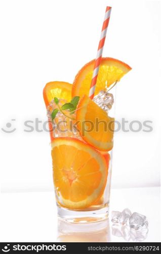 orange slices and ice cubes in cup with tube on white background