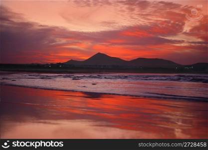 orange sunset in playa Famara, Lanzarote