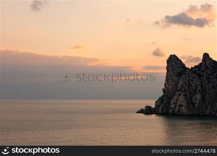 Orange sunset on rocky coast of Black Sea. Novyi Svet. Crimea. Ukraine