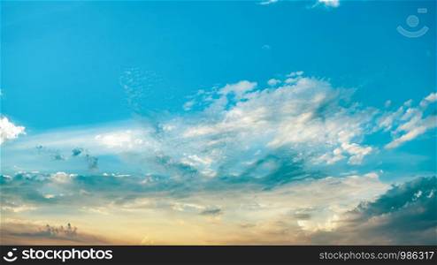 Orange sunset sky background. Soft clouds and blue sky with sunlight background