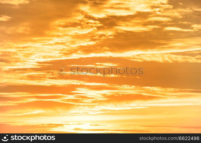 Orange sunset sky with clouds for nature background