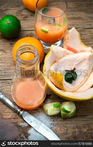 orange tangerine juice on the background of the rind in the rural style. fresh orange juice