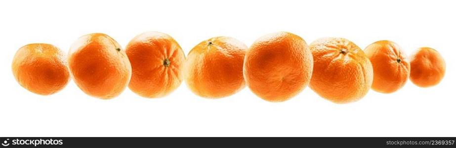 Orange tangerines levitate on a white background.. Orange tangerines levitate on a white background