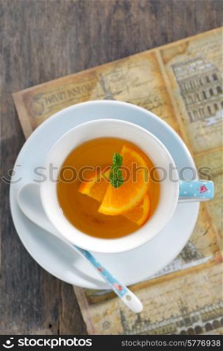 Orange tea in cup with leaf mint