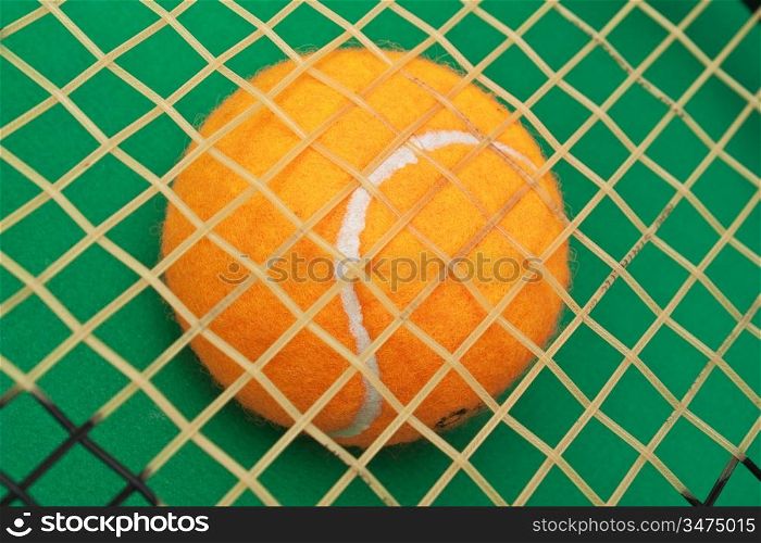 orange tennis ball on a green background