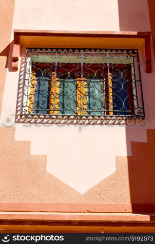 orange window in morocco africa old construction and brown wall red carpet