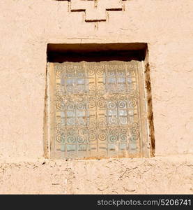 orange window in morocco africa old construction and brown wall red carpet