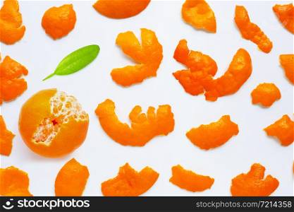 Orange with peel on white background. Top view