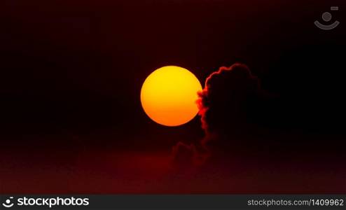 Orange - yellow Sun at sunset against red sky with back lit cloud. Sun at sunset against red sky with back lit cloud