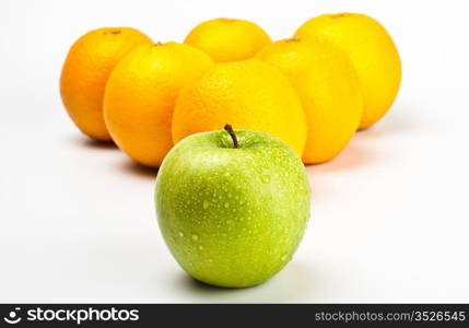 oranges and apple like billiard balls on grey background