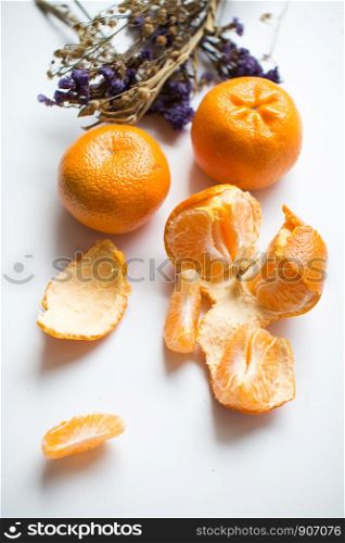 Oranges and peels on white background