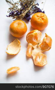 Oranges and peels on white background