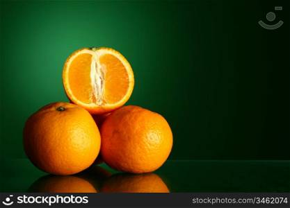 oranges isolated on green background