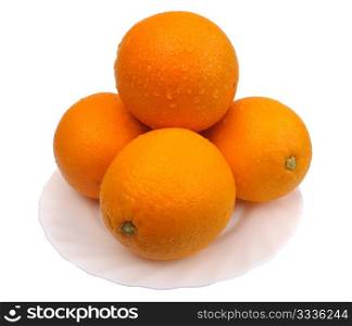 Oranges on a white plate on a white background, isolated