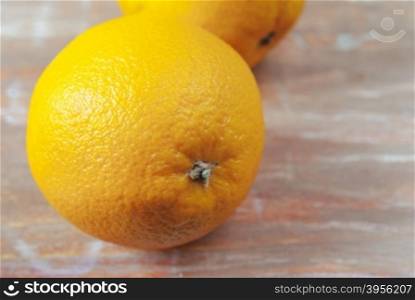 oranges on weathered wooden table. the orange on the old wooden background