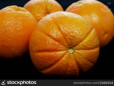 Oranges. Oranges gathered towards black background
