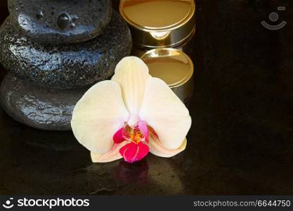 orchid flower spa treatment with massage stones