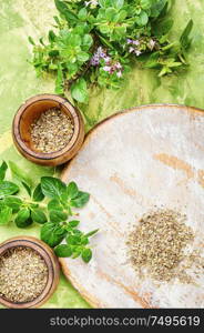 Oregano or marjoram leaves in mortar.Bunch healing herbs.Flat lay. Fresh and dried oregano herb