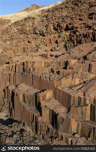 Organ Pipes rock formation at Burnt Mountain near the town of Khorixas in Namibia, Africa. They are a rock formation of columnar basalt which resemble organ pipes. Formed about 150 million years ago.