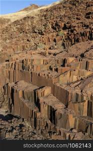 Organ Pipes rock formation at Burnt Mountain near the town of Khorixas in Namibia, Africa. They are a rock formation of columnar basalt which resemble organ pipes. Formed about 150 million years ago.