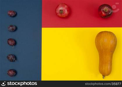 Organic autumn fruits and nuts isolated on split background with copy space