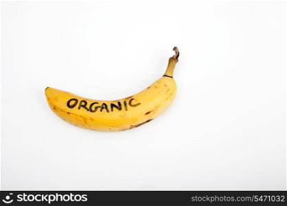 Organic banana against white background