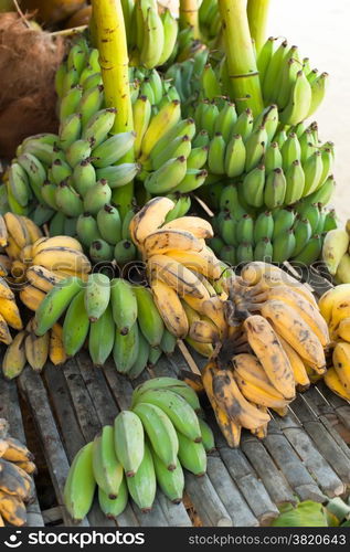 Organic bananas for sale at outdoor asian marketplace. Food background