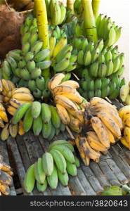 Organic bananas for sale at outdoor asian marketplace. Food background