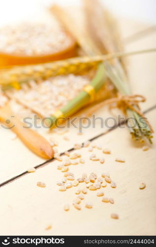 organic barley grains over rustic wood table macro closeup