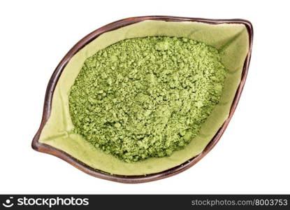 organic barley grass powder on an isolated leaf shaped ceramic bowl, top view