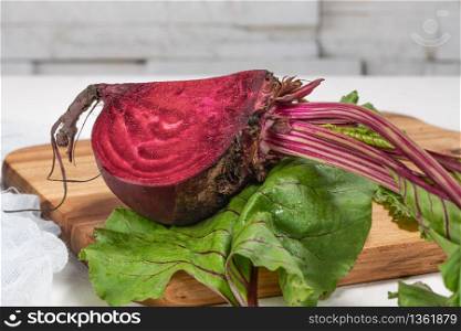 Organic beetroot vegetable / fresh red beet root harvested on wooden board
