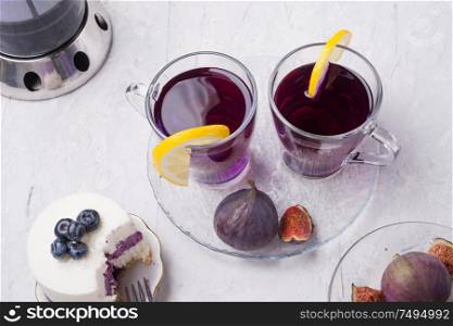 organic Butterfly pea, clitoria or Blue pea flower herbal tea. Thai blue tea. served with lemon, fresh figs and blueberry cake.
